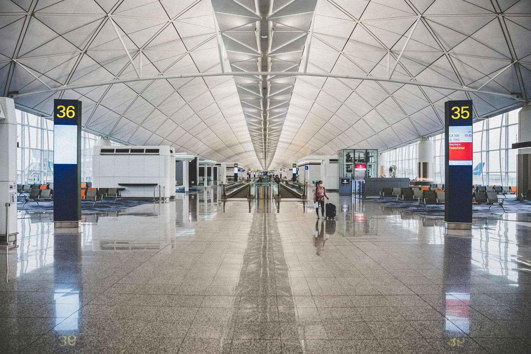 Near-empty concourse with strong perspective to the vanishing point, Hong Kong International Airport